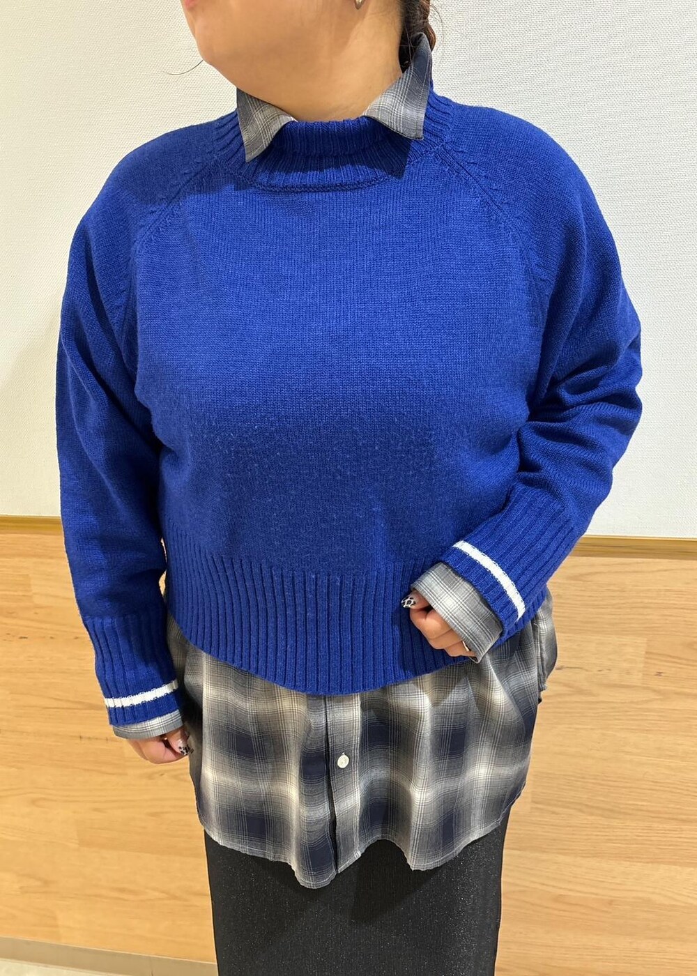 ブラック系のスカート、ブラック系のトートバッグ、ブルー系のニット/セーターを着用したレディースの秋コーディネートの7枚目の写真