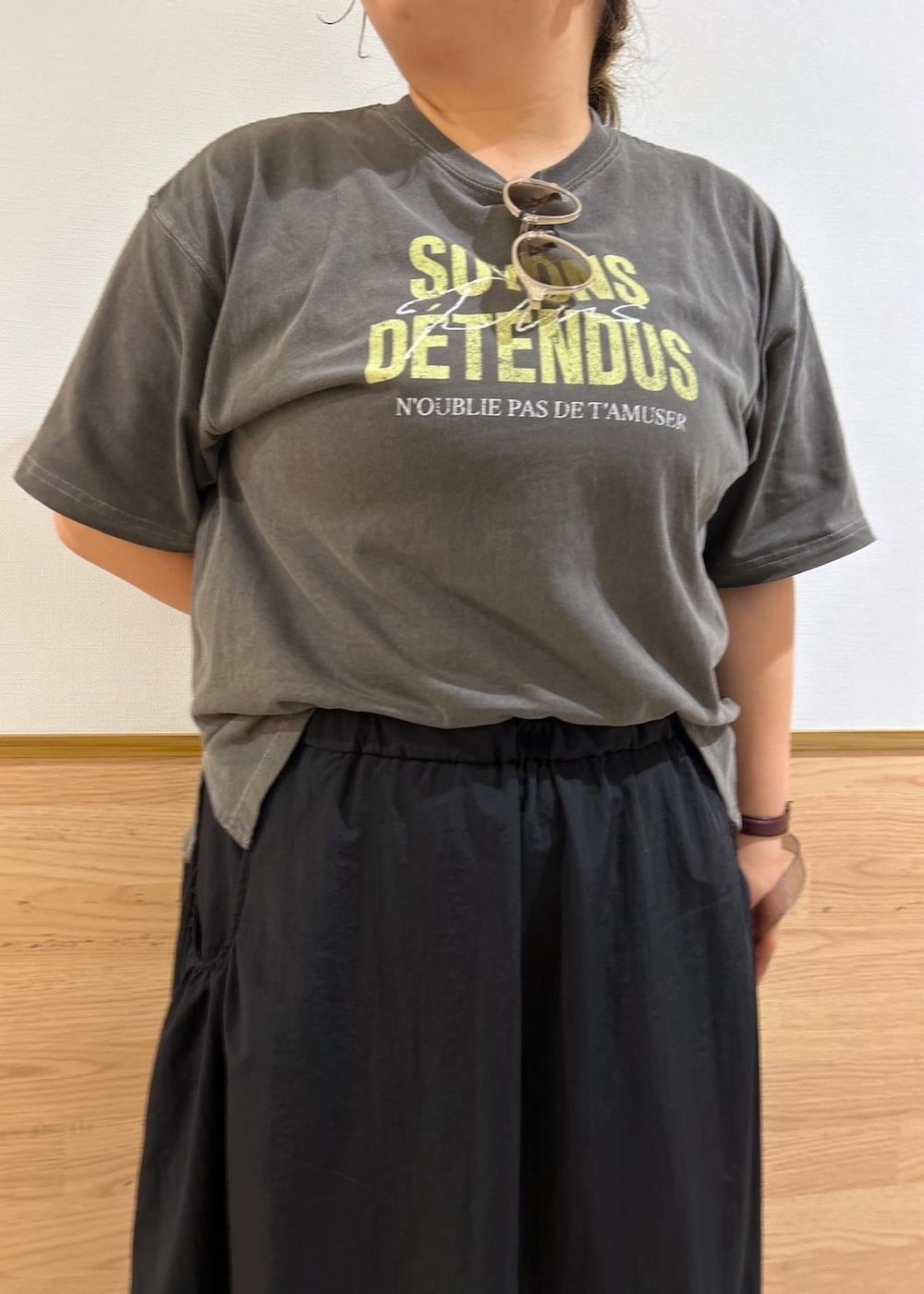 ブラック系のスカート、シルバー系のサンダル、グレー系のショルダーバッグを着用したレディースの夏コーディネートの2枚目の写真