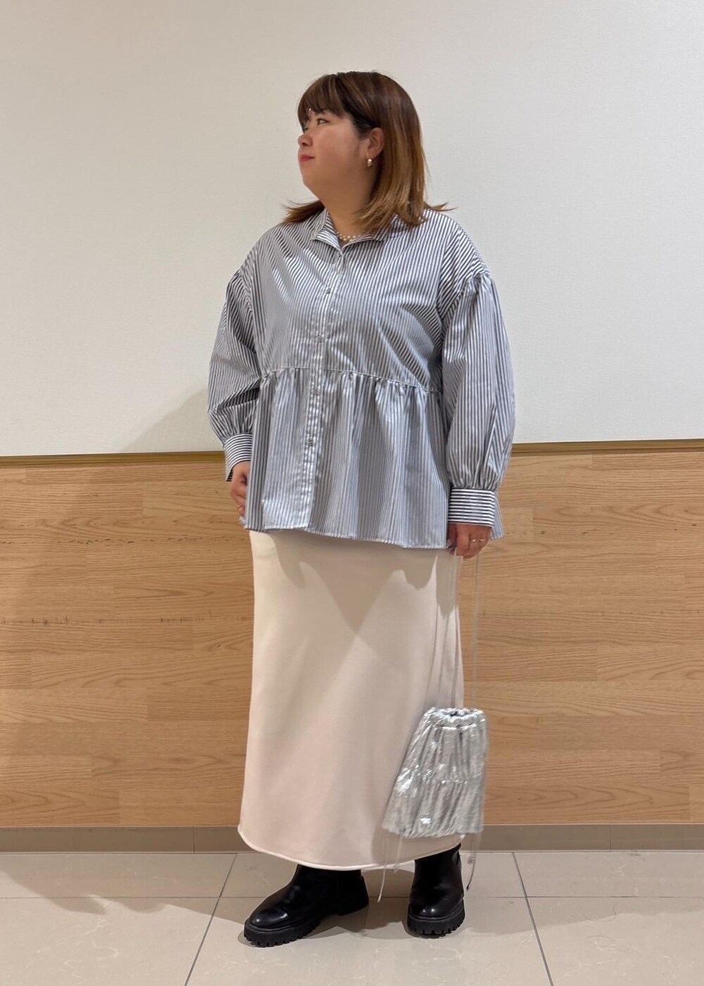 ベージュ系のスカート、ベージュ系のニット/セーター、シルバー系のショルダーバッグを着用したレディースの冬コーディネートの6枚目の写真