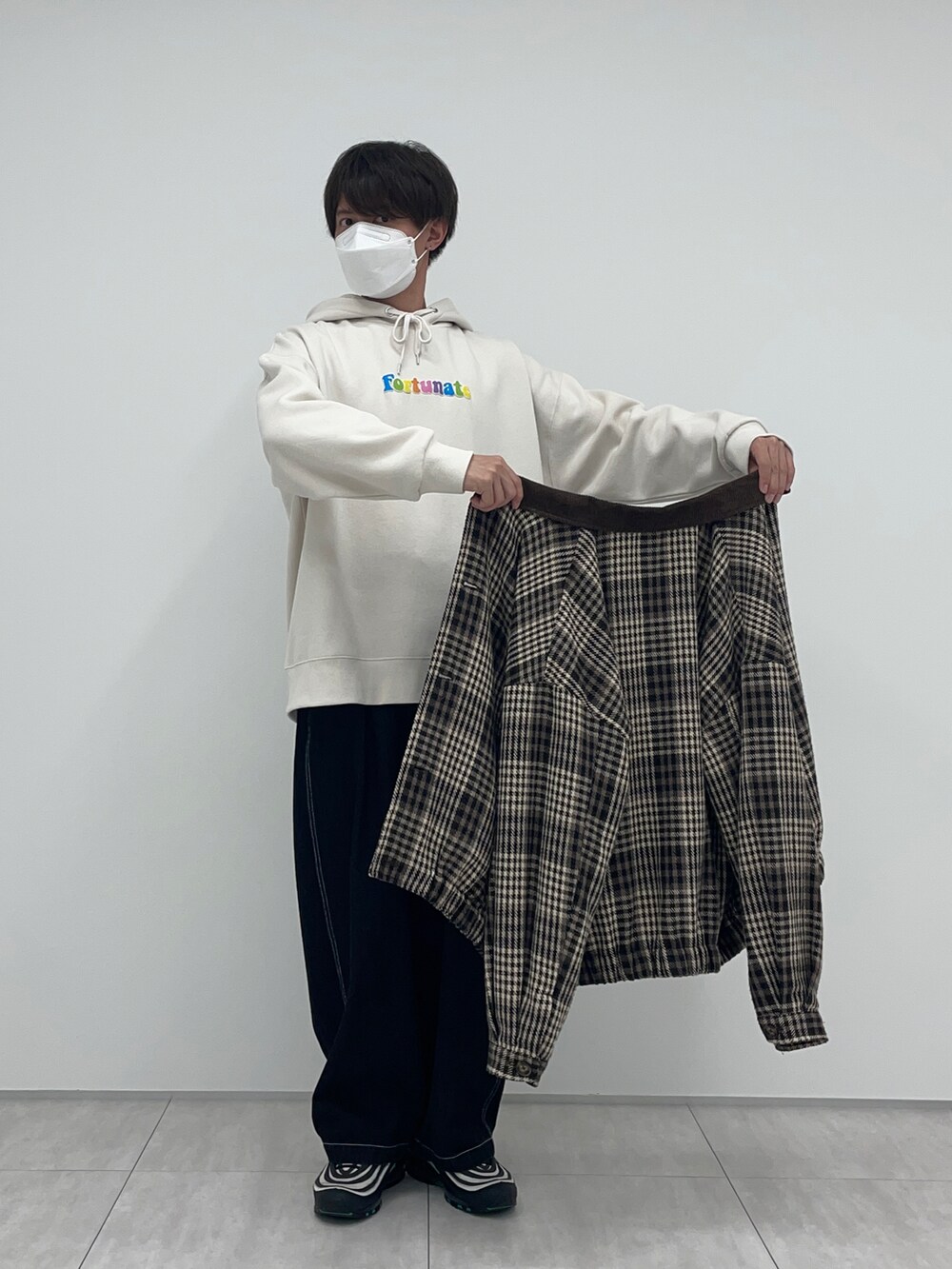 ブラック系のその他パンツ、ホワイト系のパーカー、ブラウン系のブルゾンを着用したメンズの冬コーディネートの2枚目の写真
