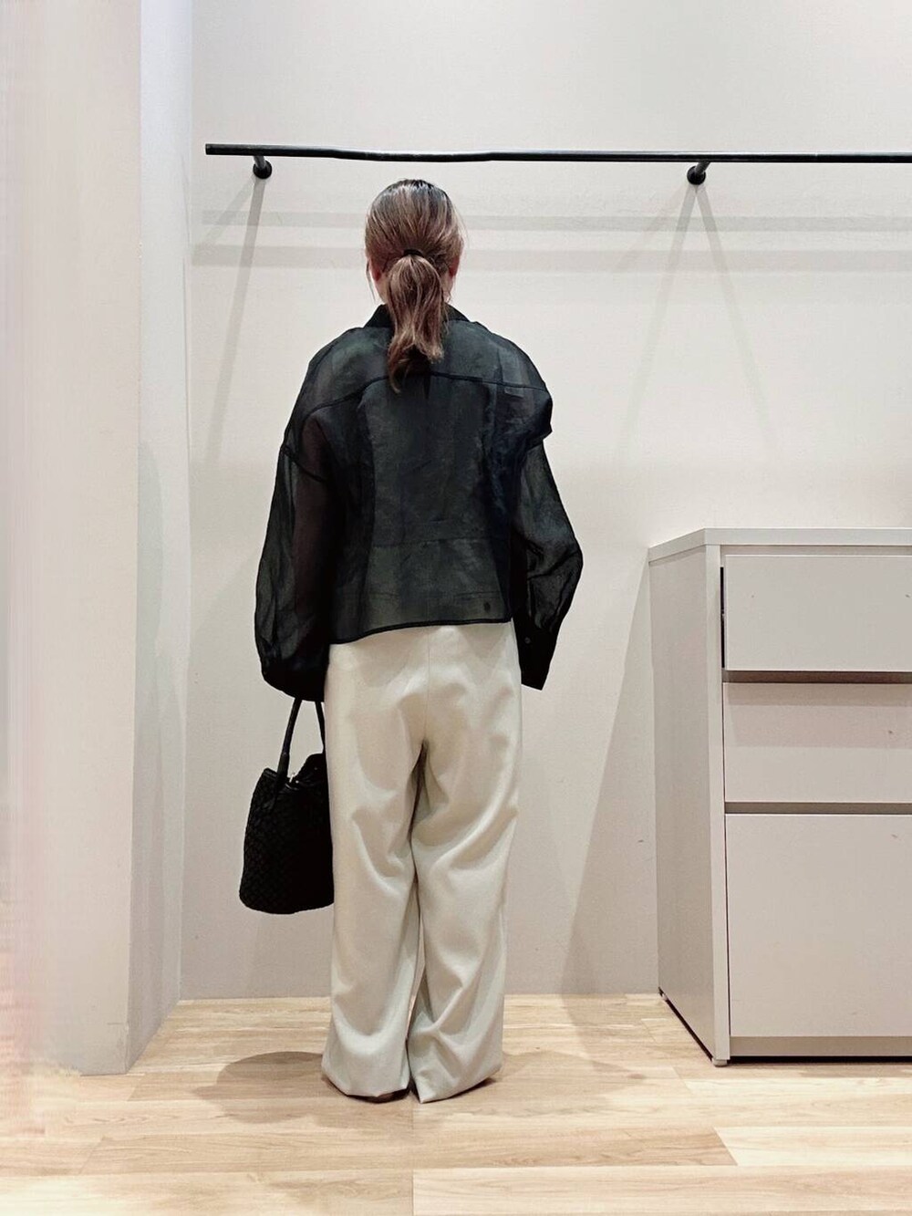 ベージュ系のサロペット/オーバーオール、ベージュ系のパンプス、ブラック系のシャツ/ブラウスを着用したレディースの春コーディネートの6枚目の写真