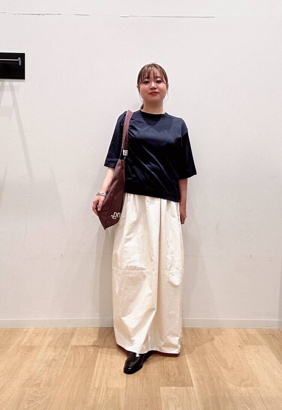 ホワイト系のスカート、ブラック系のローファー、ブルー系のTシャツ/カットソーを着用したレディースの夏コーディネートの2枚目の写真