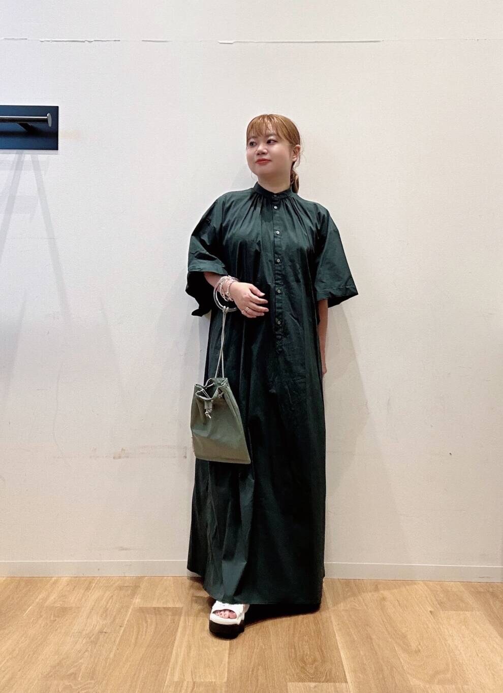 グリーン系のワンピース、グレー系のショルダーバッグ、ホワイト系のサンダルを着用したレディースの夏コーディネートの2枚目の写真