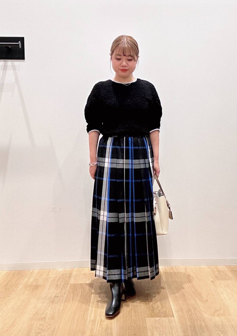 ホワイト系のトートバッグ、ブラック系のスカート、ブラック系のTシャツ/カットソーを着用したレディースの夏コーディネートの5枚目の写真