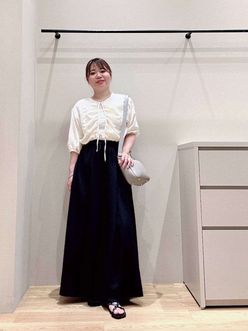 グレー系のショルダーバッグ、ベージュ系のシャツ/ブラウス、ブルー系のその他パンツを着用したレディースの春コーディネートの3枚目の写真