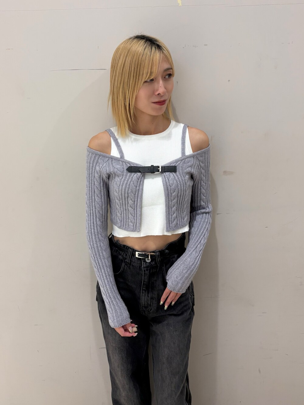 ブラック系のデニムパンツ、グレー系のアンサンブルを着用したレディースの秋コーディネートの2枚目の写真