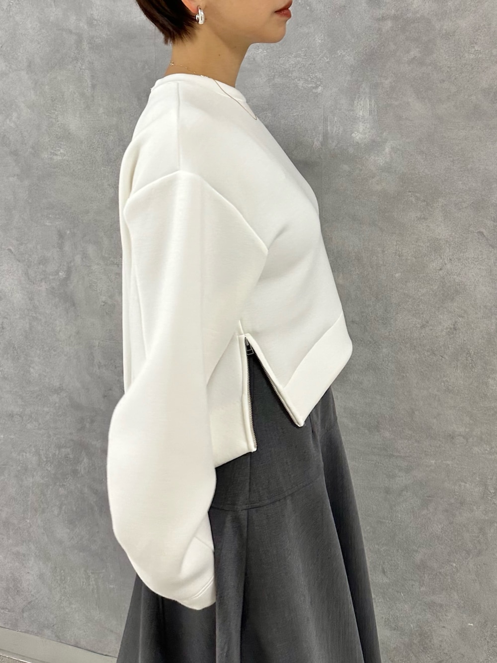 ホワイト系のTシャツ/カットソー、グレー系のスカートを着用したレディースの秋コーディネートの7枚目の写真