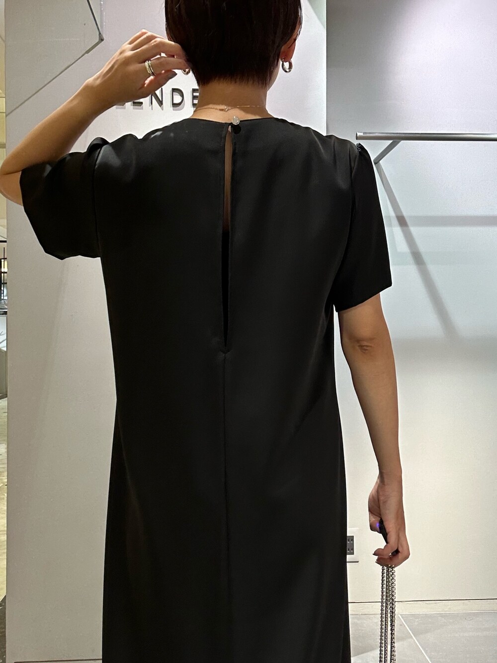 ブラック系のワンピース、ブラック系のサンダル、ブラック系のショルダーバッグを着用したレディースの夏コーディネートの6枚目の写真