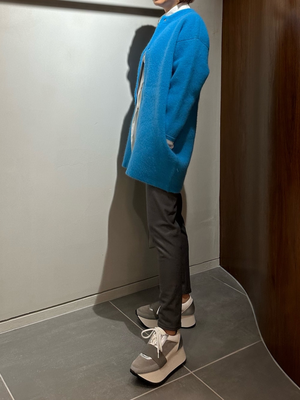 ブルー系のノーカラージャケット、ホワイト系のシャツ/ブラウス、グレー系のその他パンツを着用したレディースの秋コーディネートの2枚目の写真