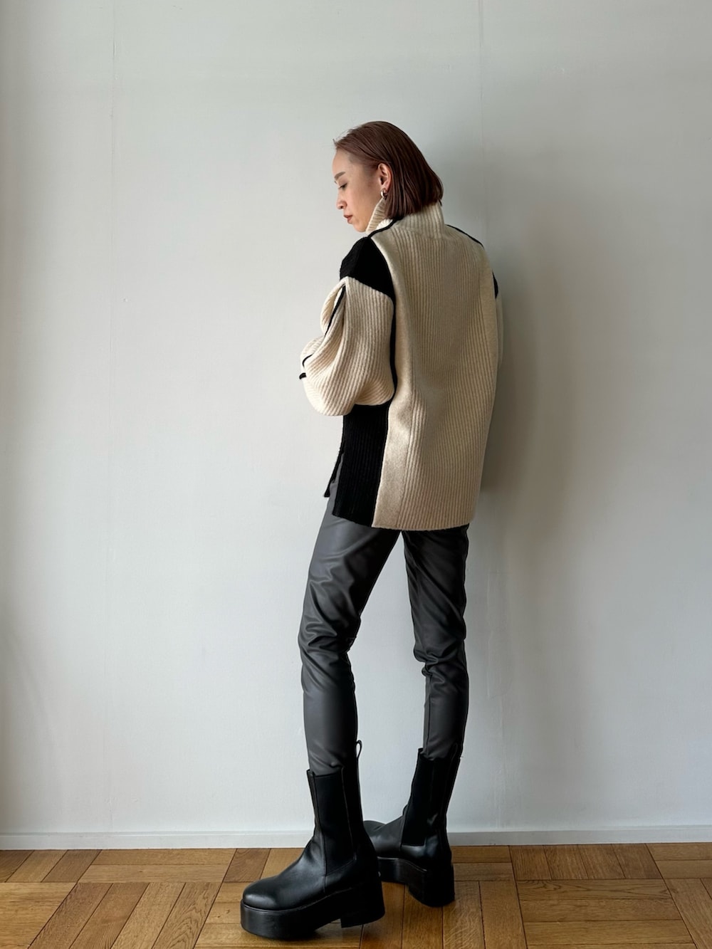 ホワイト系のニット/セーター、グレー系のその他パンツ、ブラック系のブーツを着用したレディースの秋コーディネートの7枚目の写真