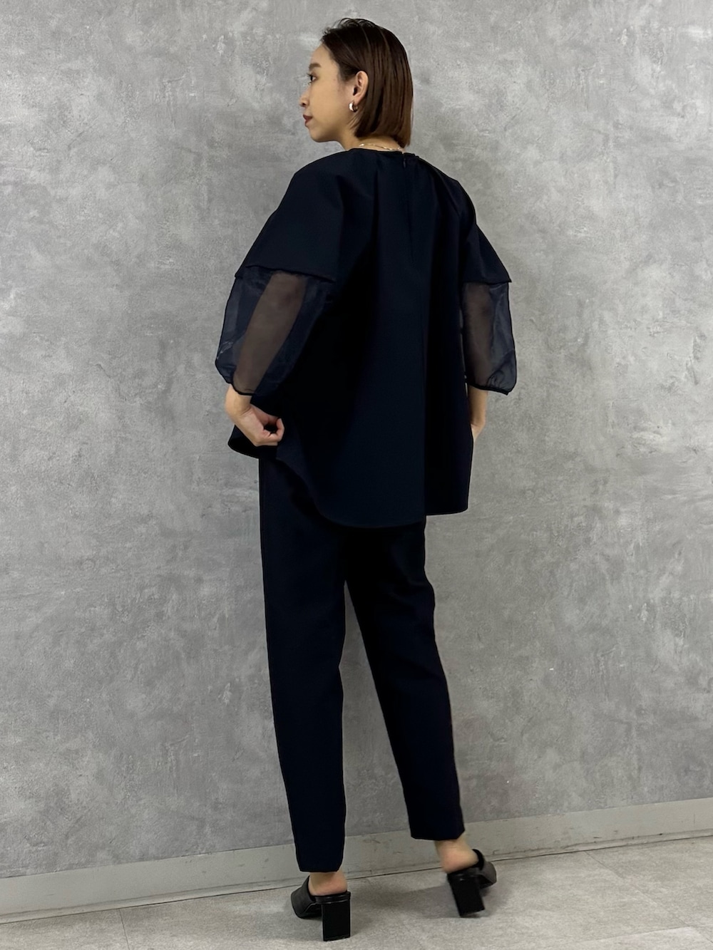 ブラック系のパンプス、ブルー系のシャツ/ブラウス、ブルー系のその他パンツを着用したレディースの春コーディネートの3枚目の写真