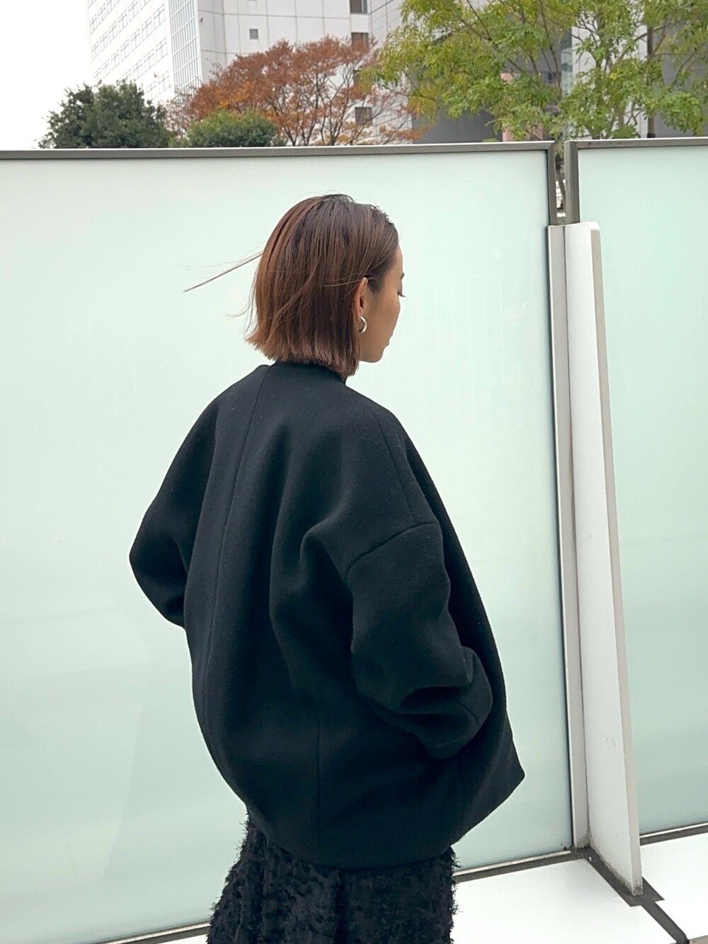 ブラック系のスニーカー、ブラック系のワンピース、ブラック系のニット/セーターを着用したレディースの冬コーディネートの9枚目の写真