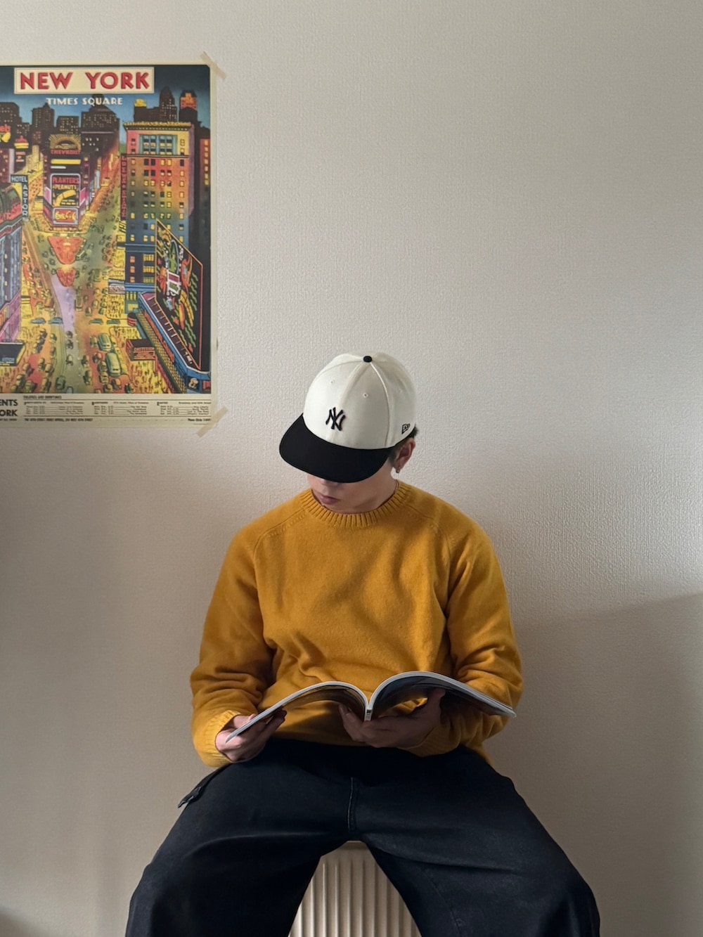 イエロー系のニット/セーター、ブラック系のデニムパンツ、ホワイト系のスニーカーを着用したメンズの冬コーディネートの3枚目の写真