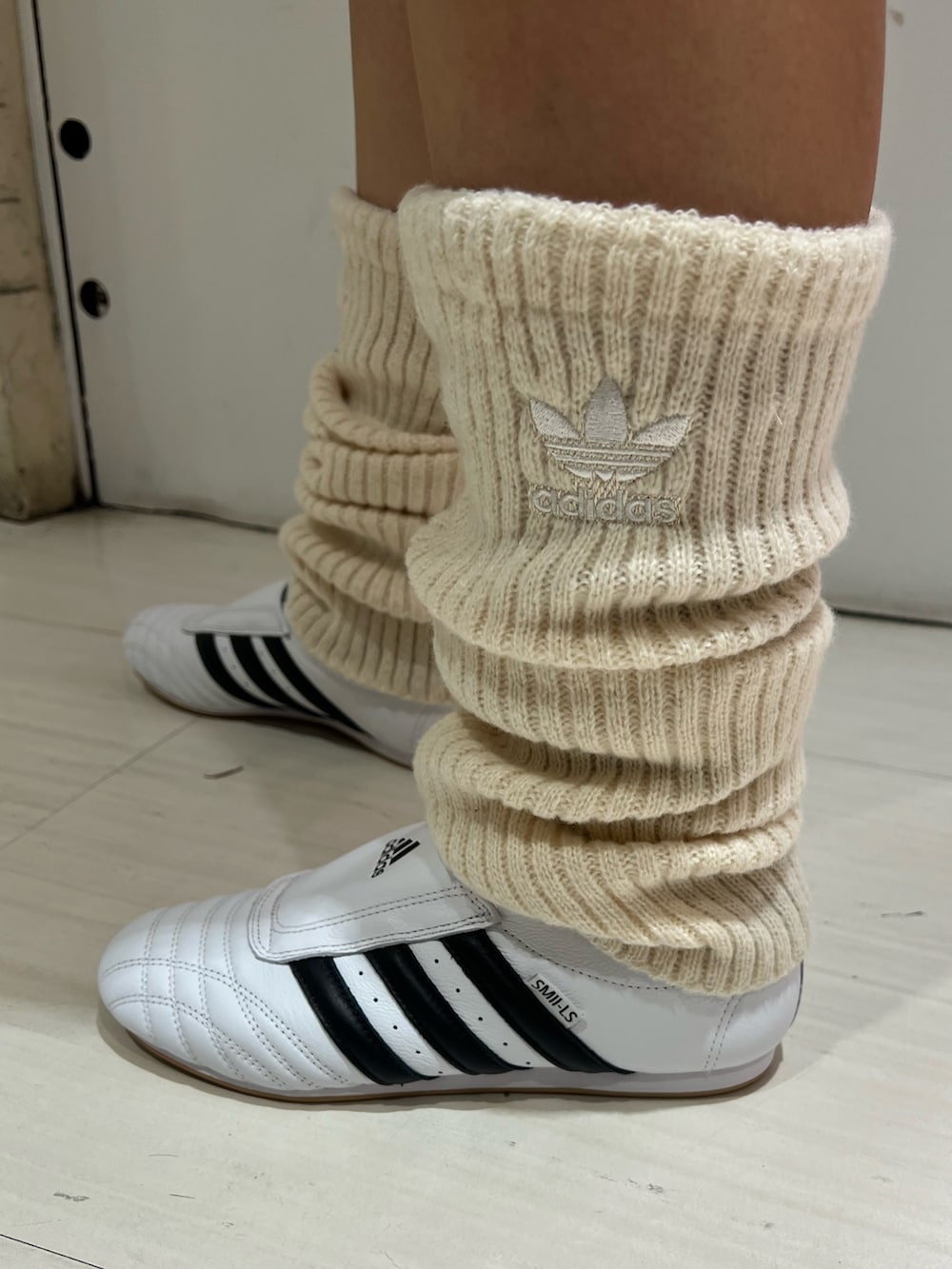 ブラウン系のジャージ、ベージュ系のスカート、ホワイト系のシューズを着用したレディースの秋コーディネートの5枚目の写真