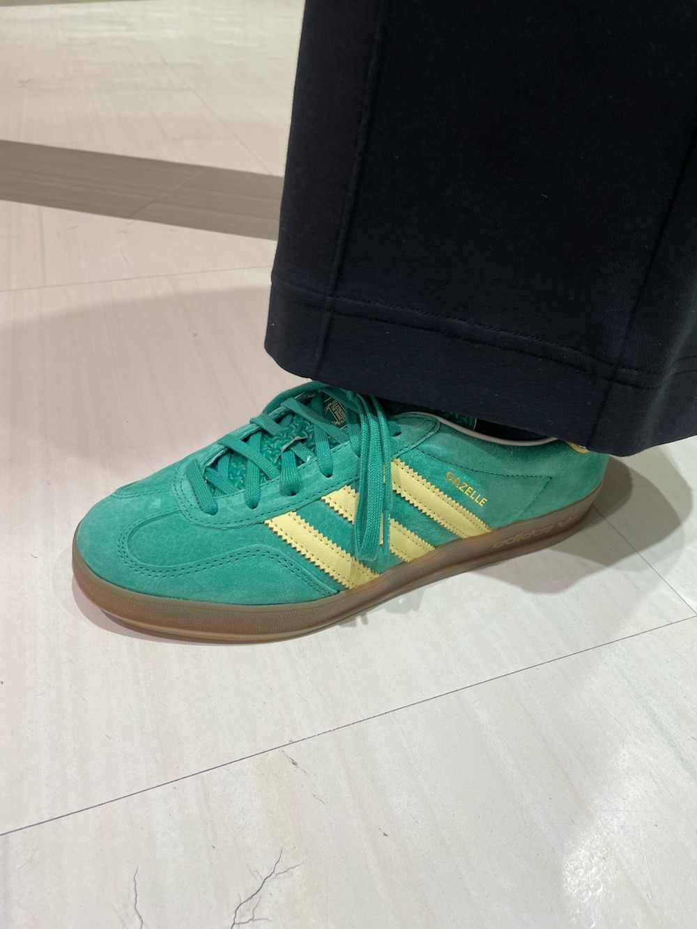 ブラック系のTシャツ/カットソー、ブラック系のその他パンツ、グリーン系のスニーカーを着用したレディースの春コーディネートの5枚目の写真