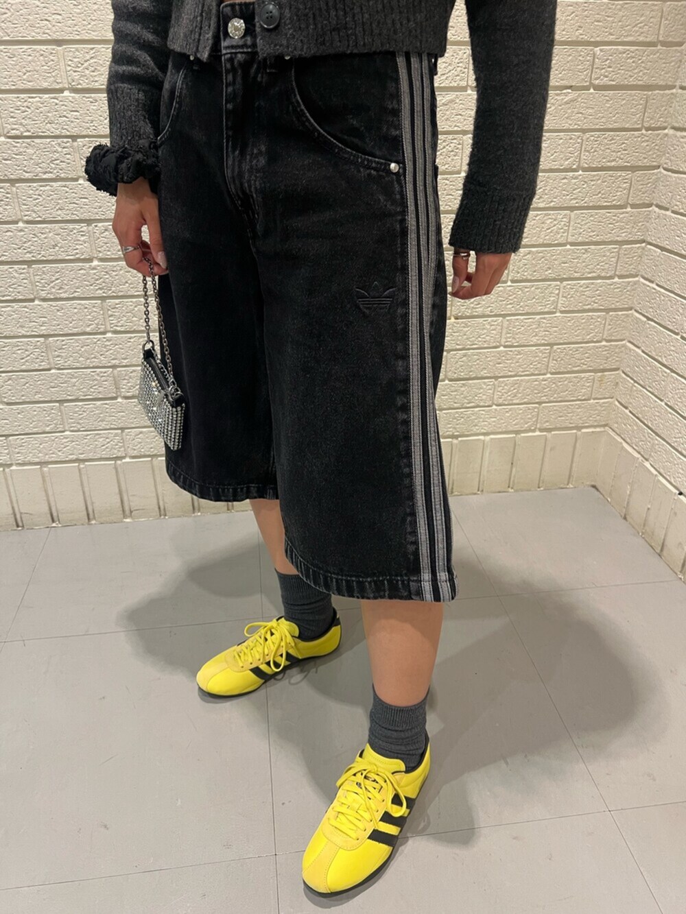 ブラック系のその他パンツ、イエロー系のスニーカーを着用したレディースの春コーディネートの3枚目の写真
