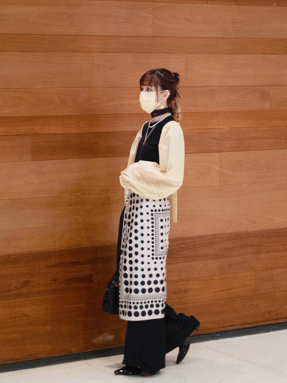 ブラック系のTシャツ/カットソー、イエロー系のカーディガン/ボレロ、ブラック系のハンドバッグを着用したレディースの夏コーディネートの3枚目の写真