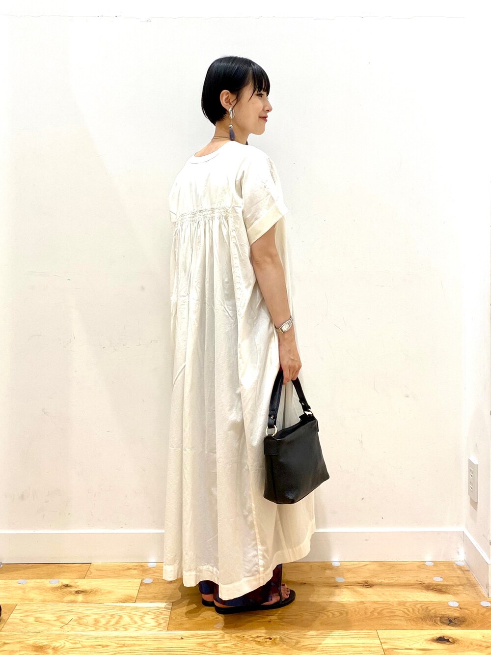 ホワイト系のワンピース、パープル系のその他パンツ、ブラック系のハンドバッグを着用したレディースの夏コーディネートの3枚目の写真