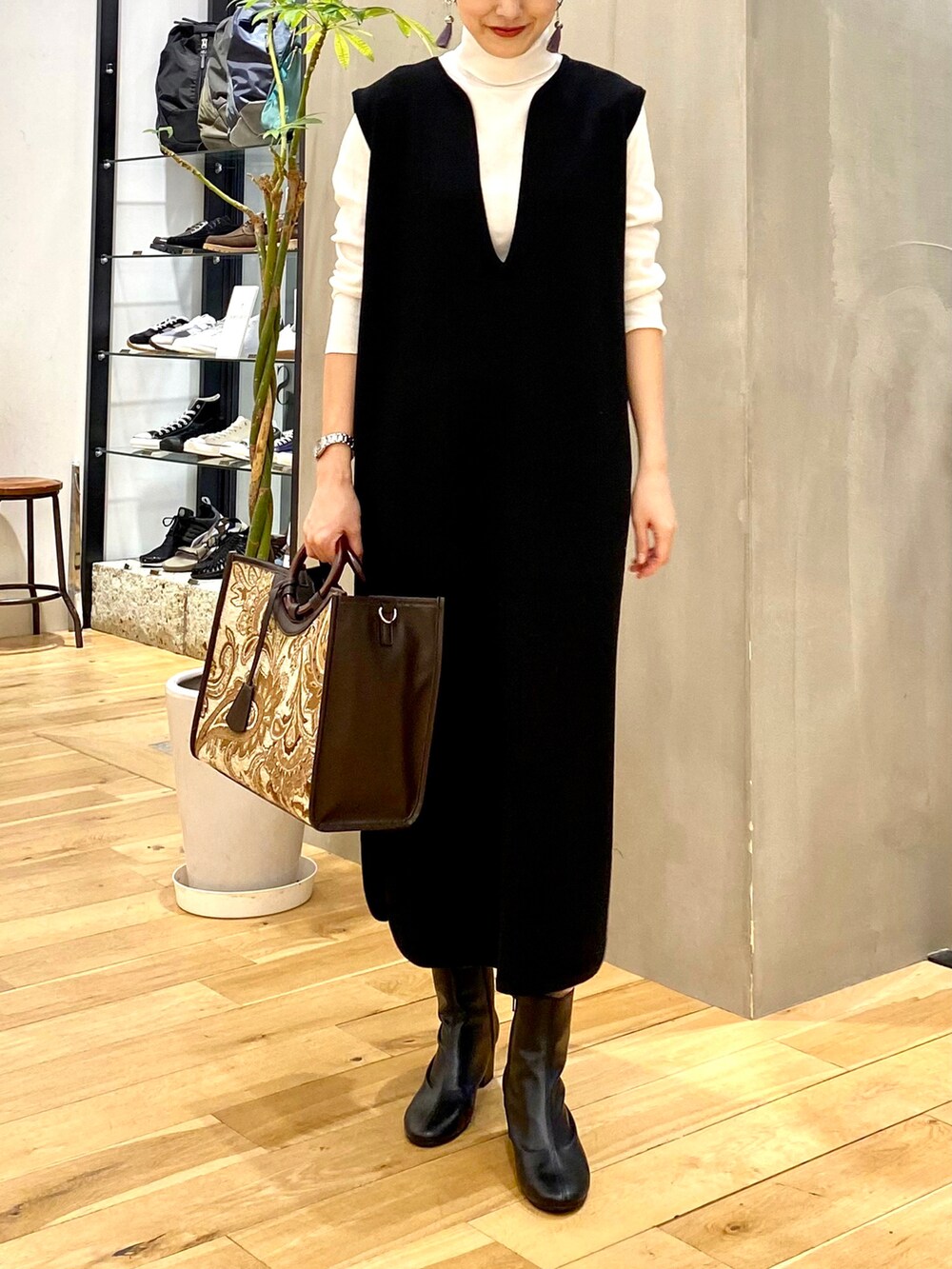 ホワイト系のTシャツ/カットソー、ブラック系のワンピース、ブラウン系のトートバッグを着用したレディースの秋コーディネートの4枚目の写真
