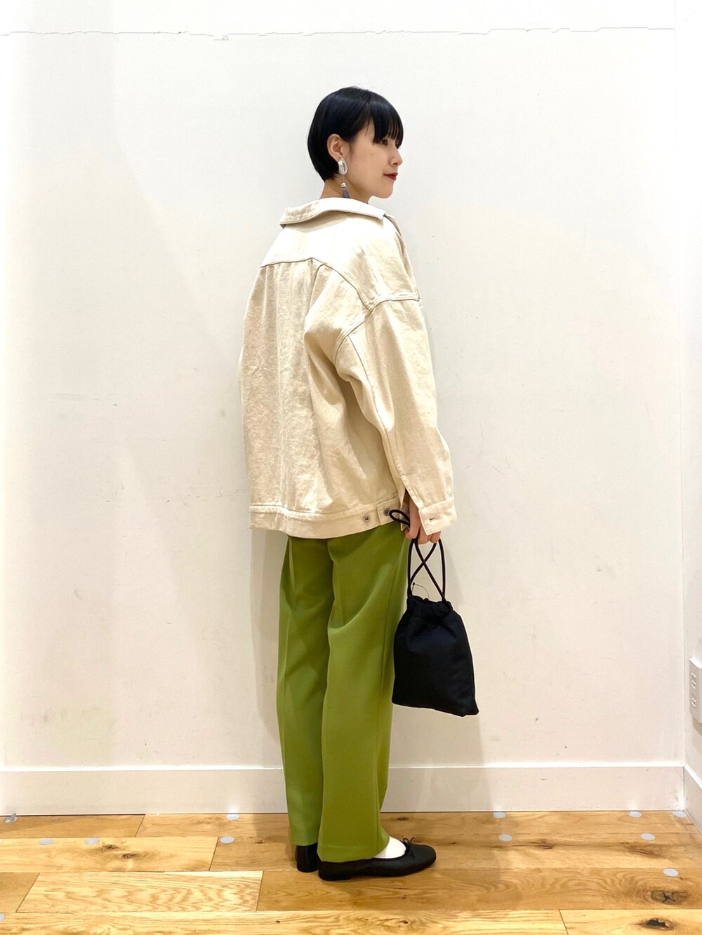 ベージュ系のカバーオール、グリーン系のその他パンツ、ブラック系のバレエシューズを着用したレディースの春コーディネートの2枚目の写真