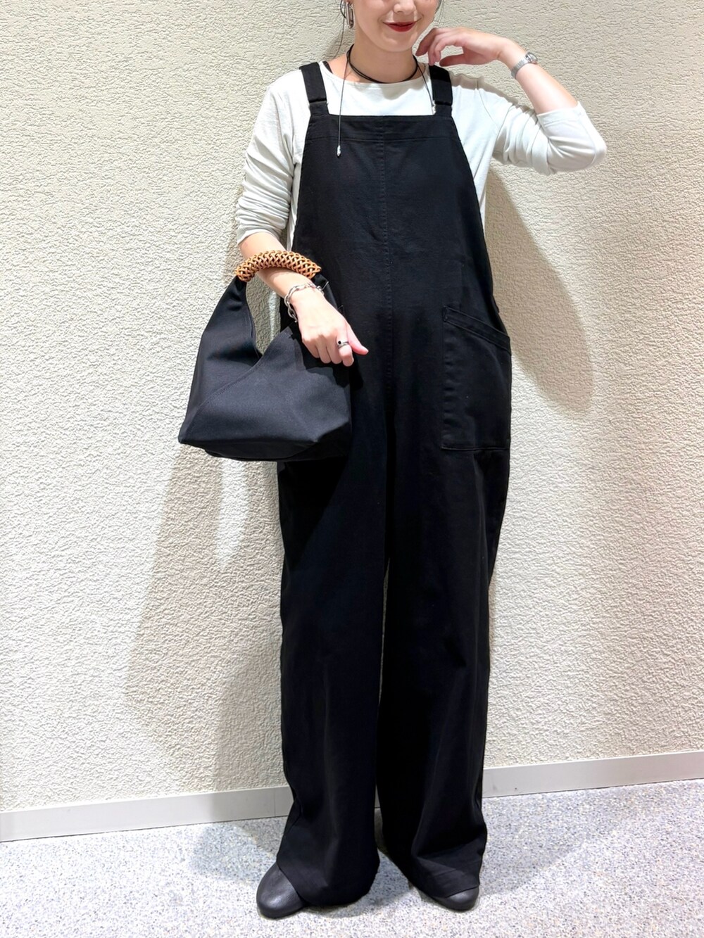 グリーン系のTシャツ/カットソー、グリーン系のTシャツ/カットソー、ブラック系のサロペット/オーバーオールを着用したレディースの秋コーディネートの4枚目の写真