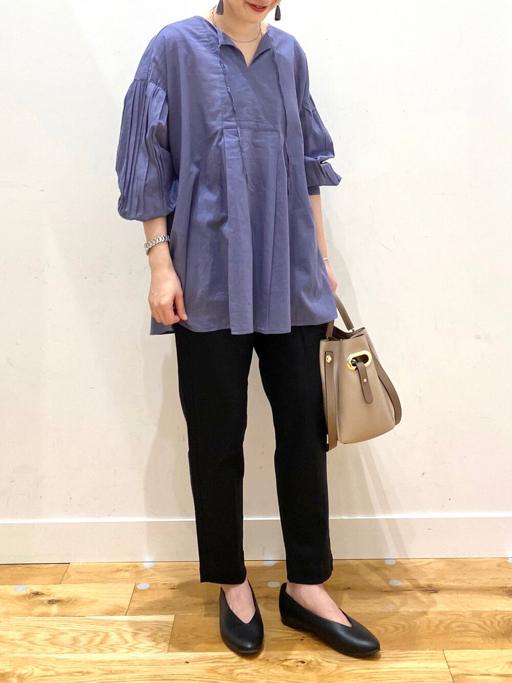 ブルー系のシャツ/ブラウス、ブラック系のその他パンツ、パープル系のトートバッグを着用したレディースの春コーディネートの4枚目の写真
