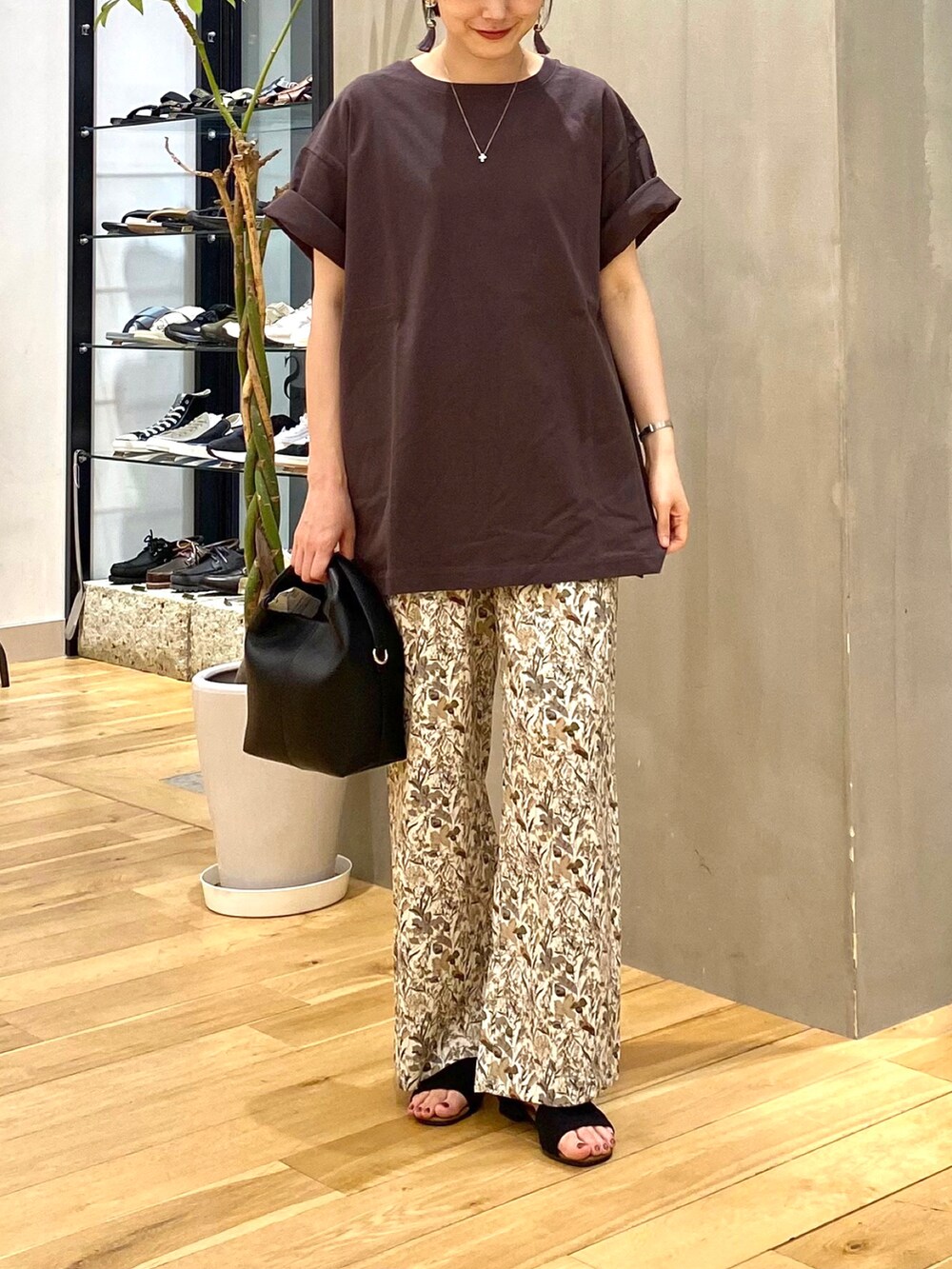 グレー系のTシャツ/カットソー、ホワイト系のその他パンツ、ブラック系のハンドバッグを着用したレディースの夏コーディネートの4枚目の写真