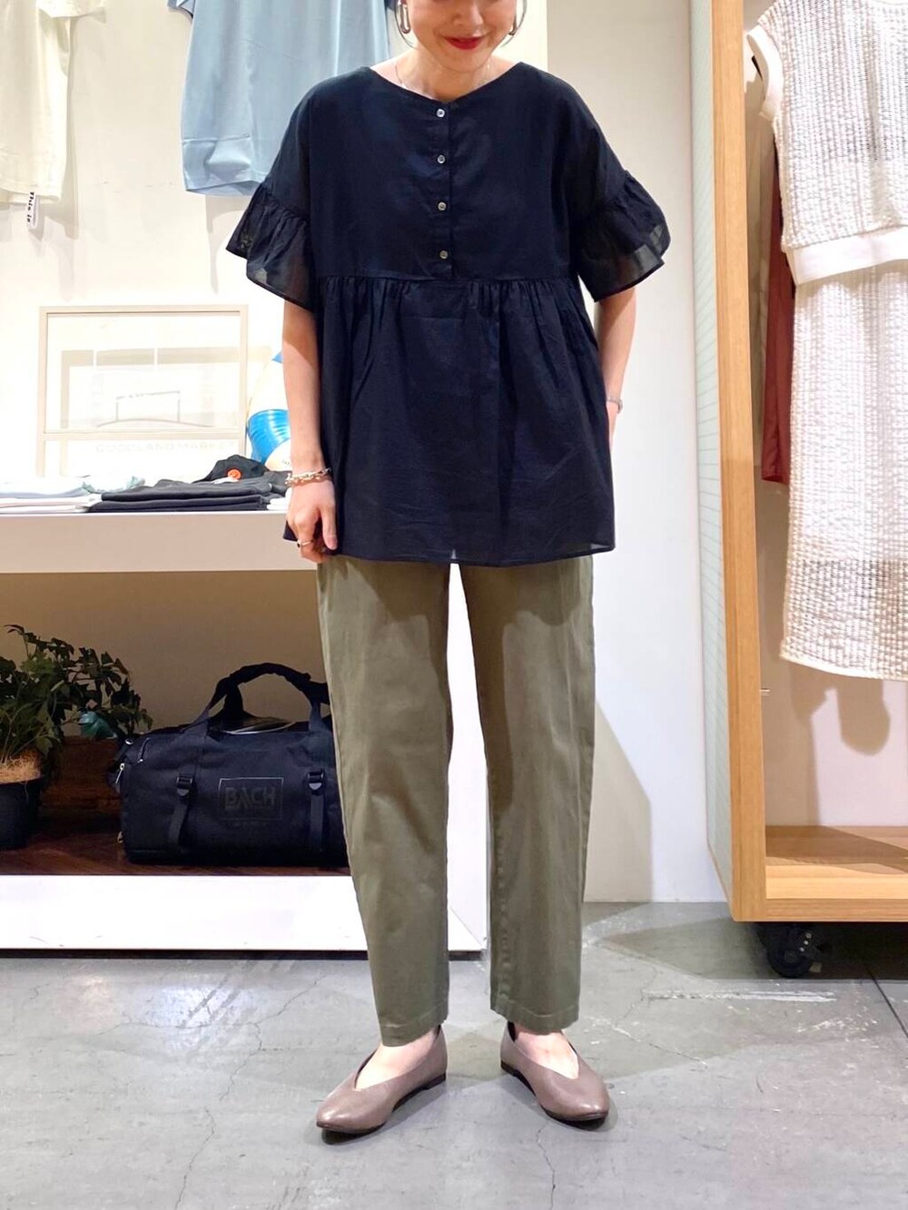 ベージュ系のパンプス、ブラック系のシャツ/ブラウス、グリーン系のその他パンツを着用したレディースの夏コーディネートの6枚目の写真