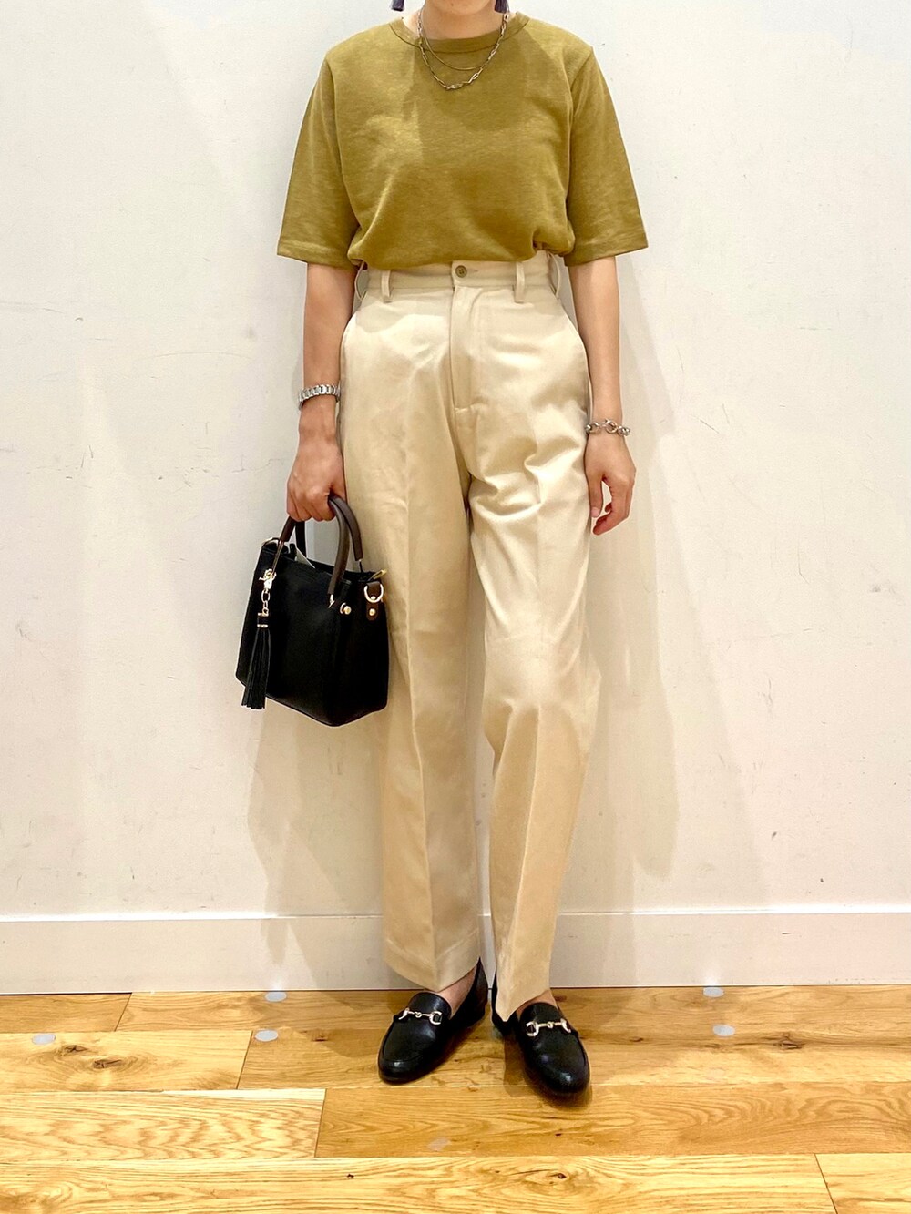 イエロー系のTシャツ/カットソー、ベージュ系のその他パンツ、ブラック系のトートバッグを着用したレディースの夏コーディネートの4枚目の写真