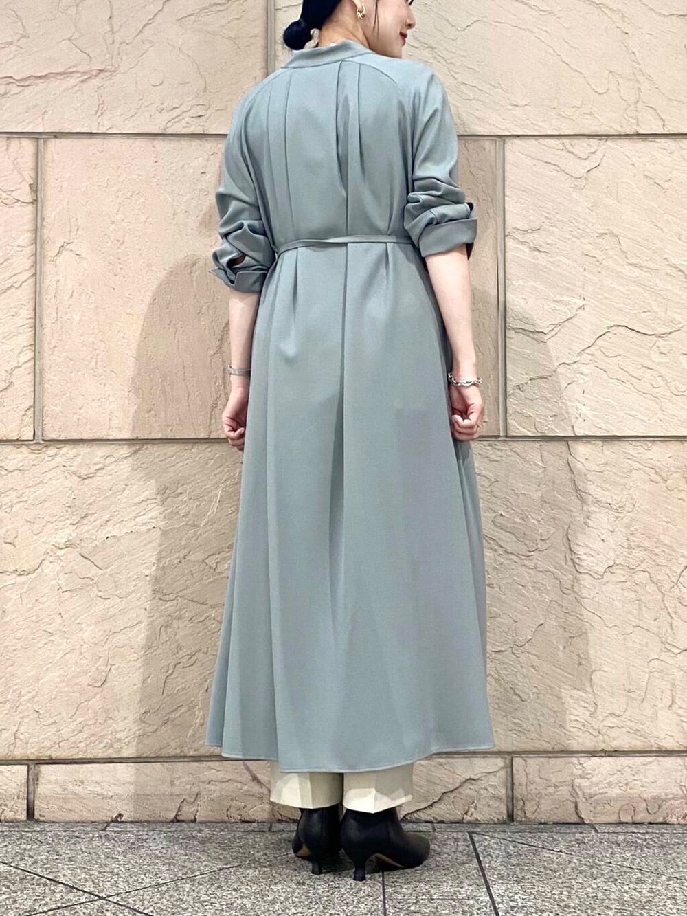 グリーン系のワンピース、ベージュ系のその他パンツ、ブラック系のブーツを着用したレディースの秋コーディネートの7枚目の写真
