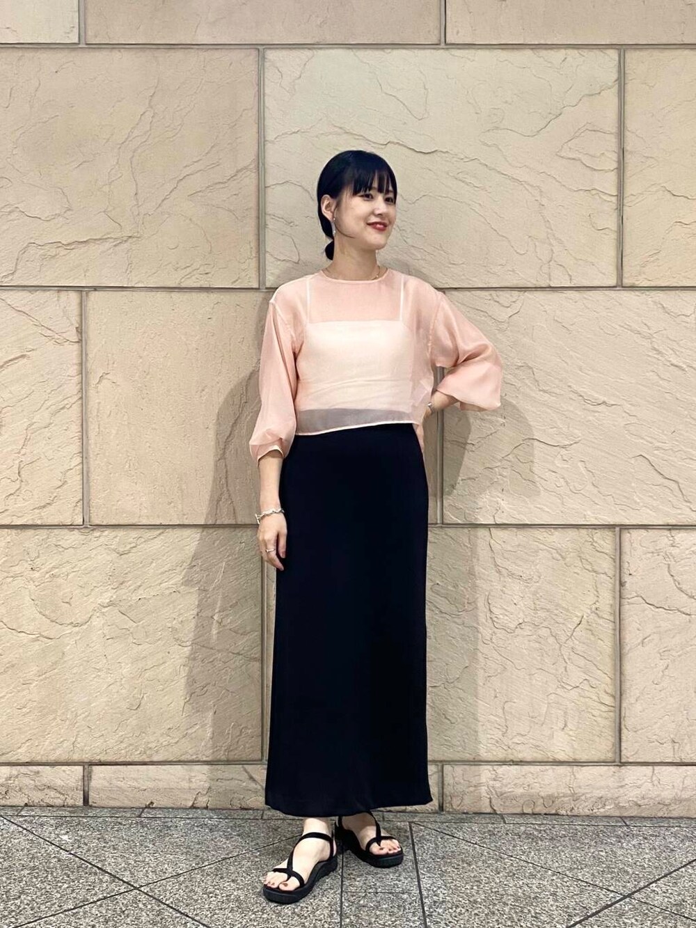 ブラック系のスカート、ピンク系のシャツ/ブラウスを着用したレディースの夏コーディネートの3枚目の写真