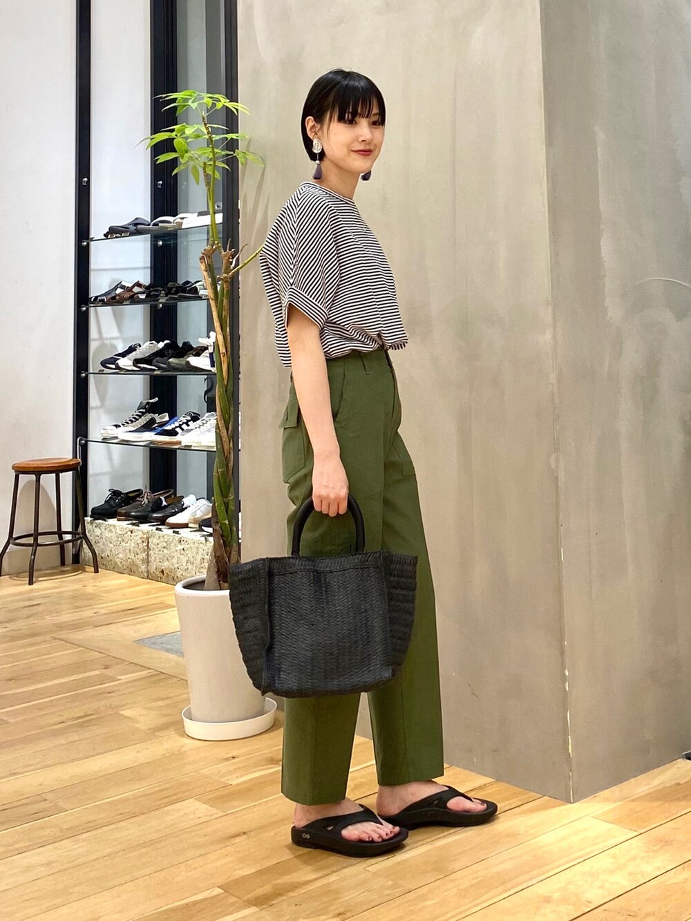 ホワイト系のTシャツ/カットソー、グリーン系のその他パンツ、ブラック系のトートバッグを着用したレディースの春コーディネートの3枚目の写真