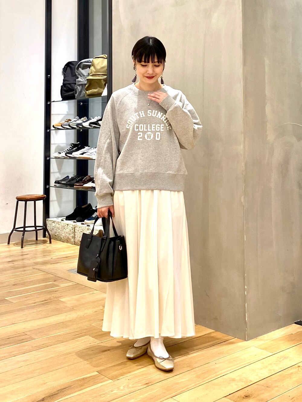 グリーン系のモッズコート、グレー系のスウェット、ホワイト系のスカートを着用したレディースの春コーディネートの3枚目の写真