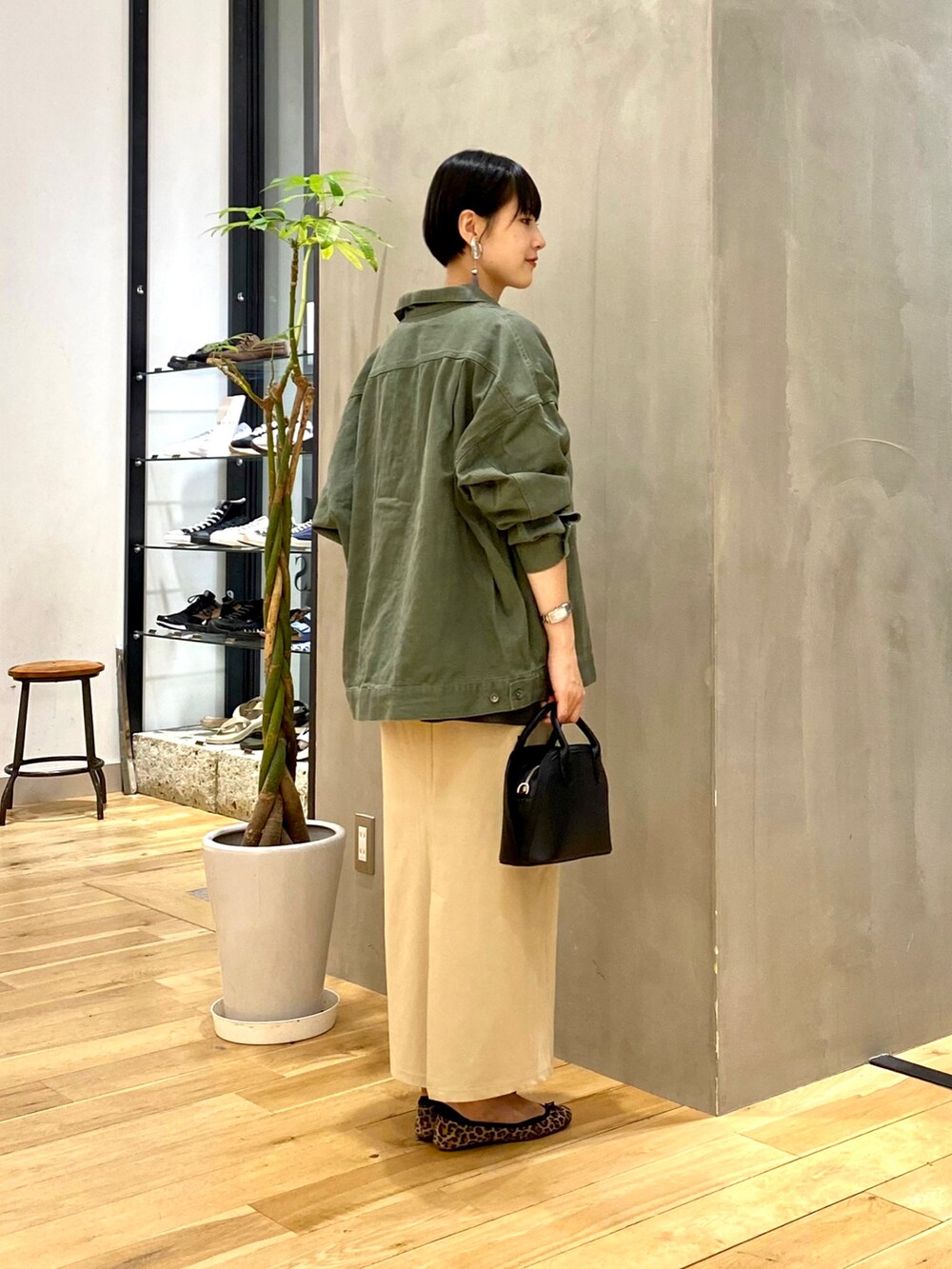 グリーン系のその他アウター、グレー系のTシャツ/カットソー、ベージュ系のスカートを着用したレディースの秋コーディネートの2枚目の写真