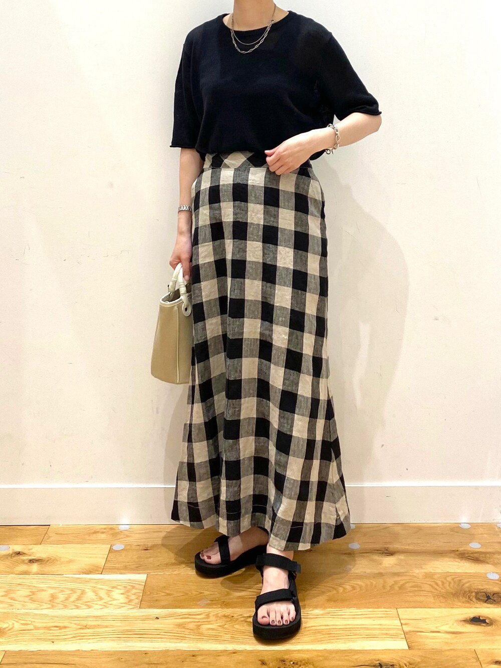 ブラック系のTシャツ/カットソー、その他のスカート、ベージュ系のショルダーバッグを着用したレディースの夏コーディネートの4枚目の写真