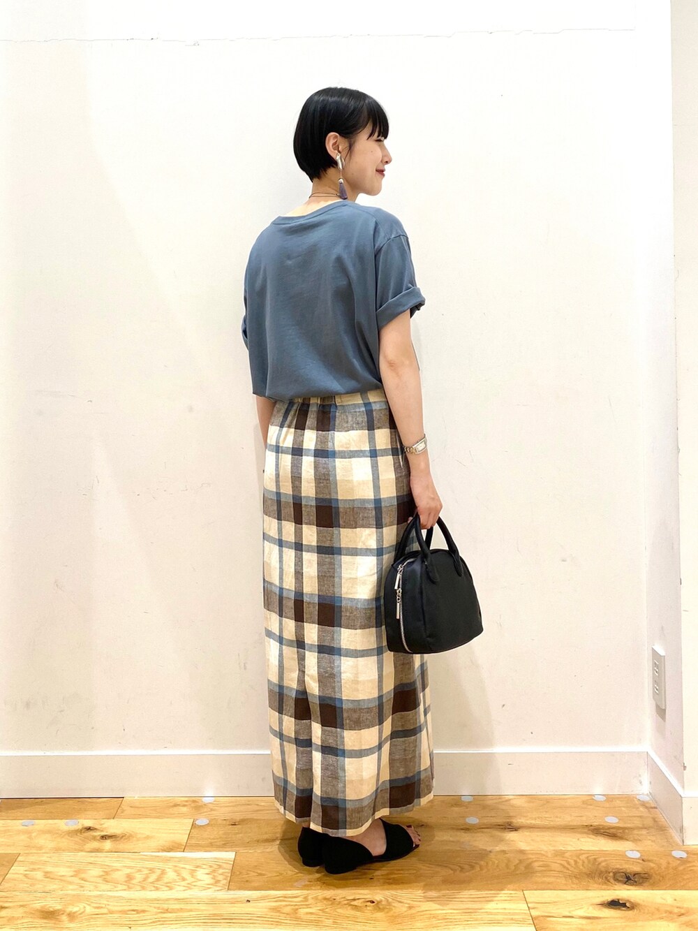 ブルー系のTシャツ/カットソー、ブルー系のスカート、ブラック系のボストンバッグを着用したレディースの夏コーディネートの3枚目の写真