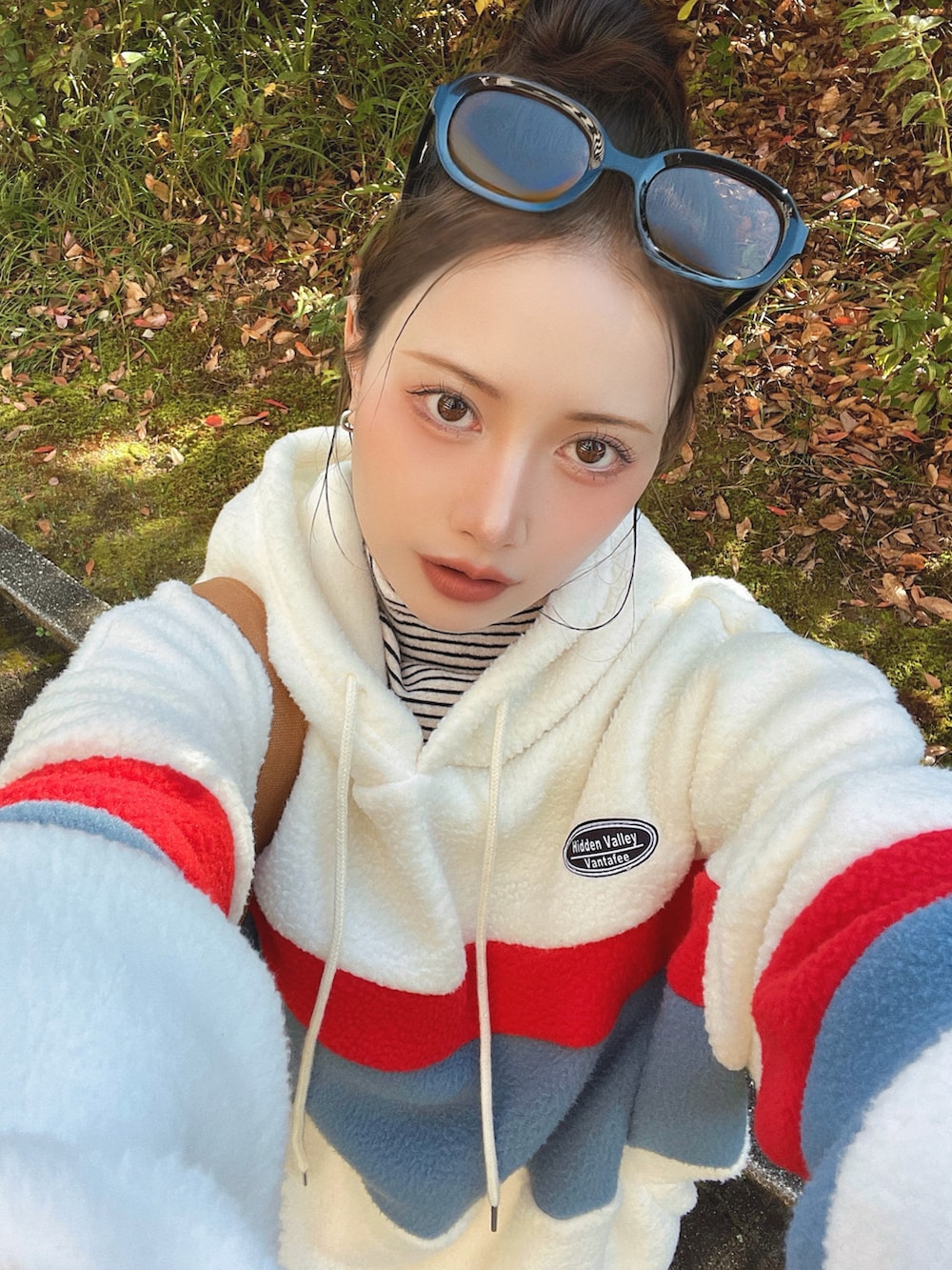 ホワイト系のブルゾン、ブルー系のセットアップ、ブラウン系のブーツを着用したレディースの冬コーディネートの3枚目の写真