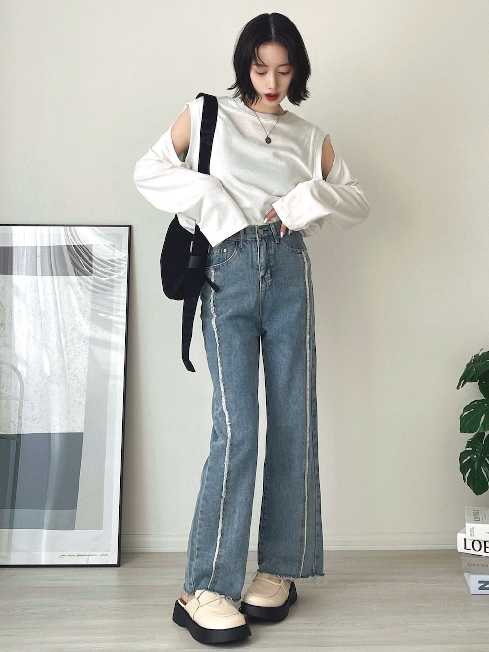 ブルー系のデニムパンツ、ホワイト系のローファー、ホワイト系のTシャツ/カットソーを着用したレディースの冬コーディネートの2枚目の写真