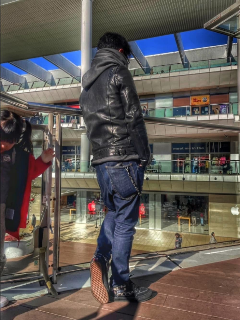 ブラック系のライダースジャケット、ブルー系のデニムパンツ、ブラック系のスニーカーを着用したメンズの冬コーディネートの3枚目の写真