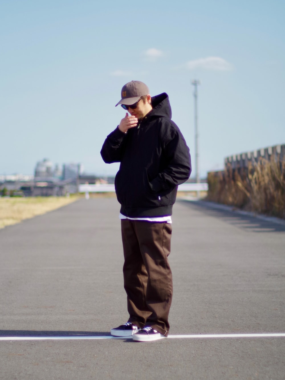 ブラック系のその他アウター、ブラウン系のチノパンツ、ブラック系のスニーカーを着用したメンズの春コーディネートの3枚目の写真