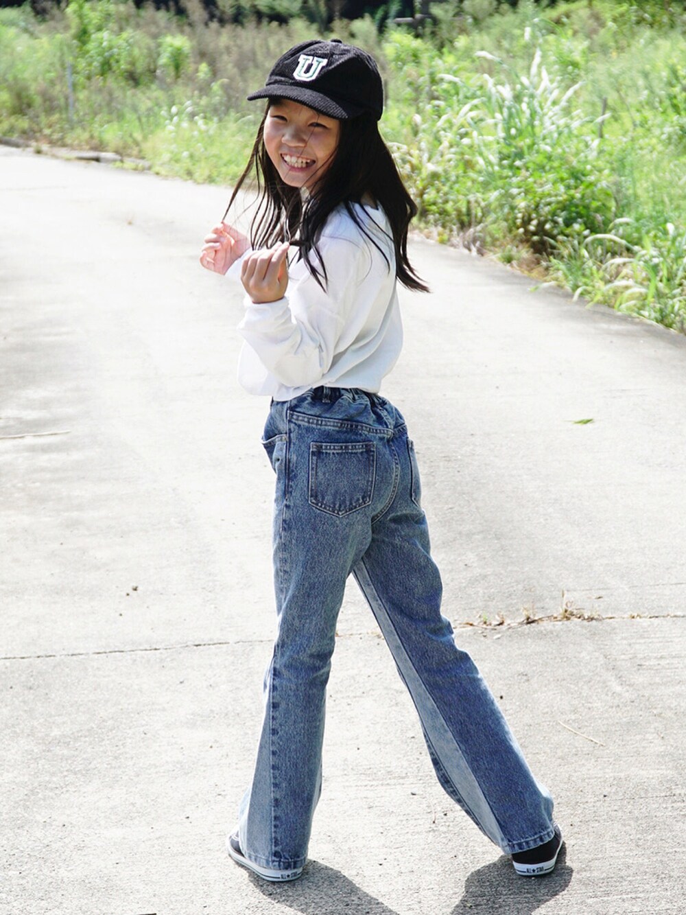 ホワイト系のTシャツ/カットソー、ブルー系のデニムパンツ、ブラック系のスニーカーを着用したキッズの秋コーディネートの5枚目の写真