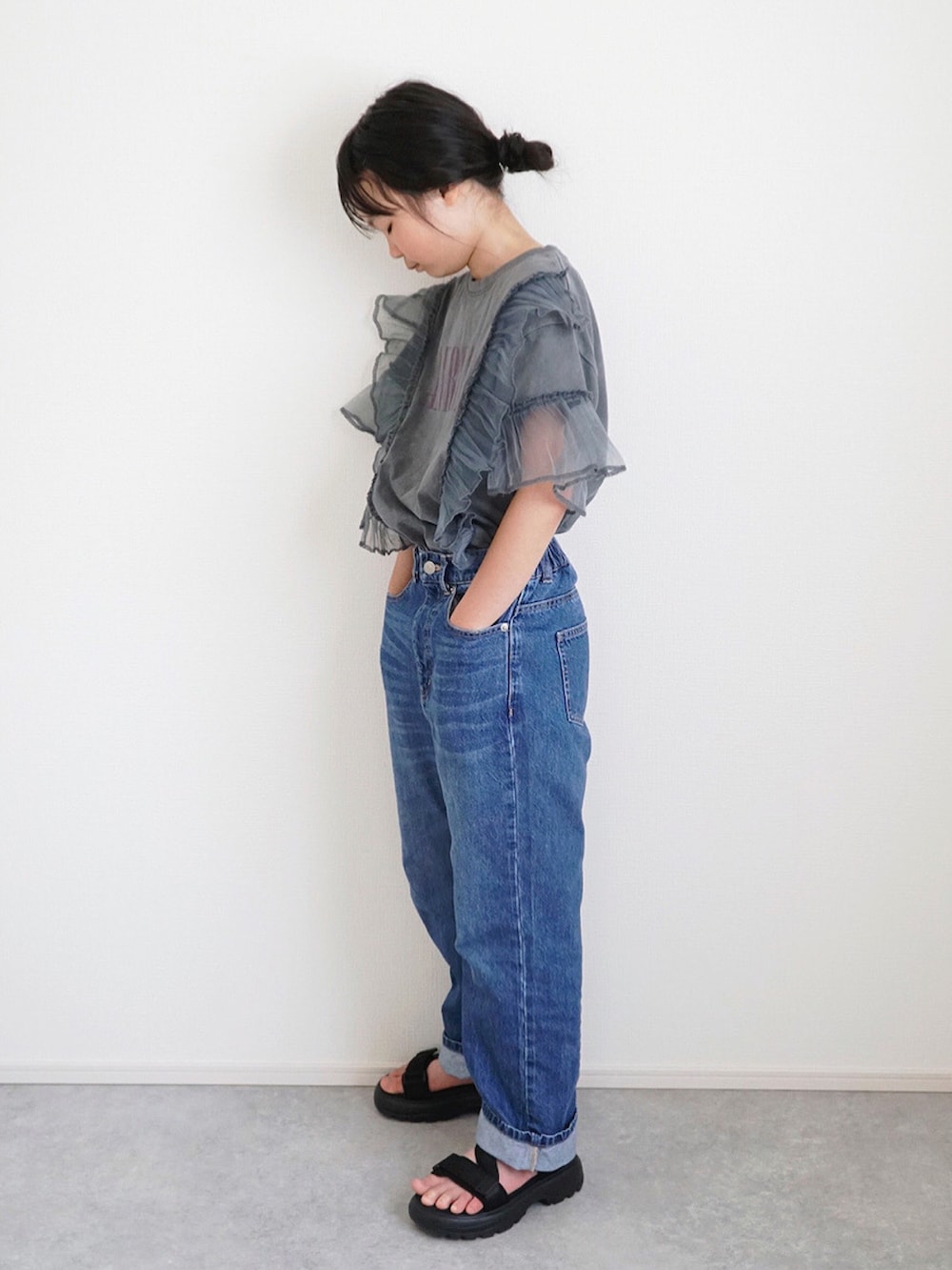 グレー系のTシャツ/カットソー、ブルー系のデニムパンツ、ブラック系のサンダルを着用したキッズの春コーディネートの2枚目の写真