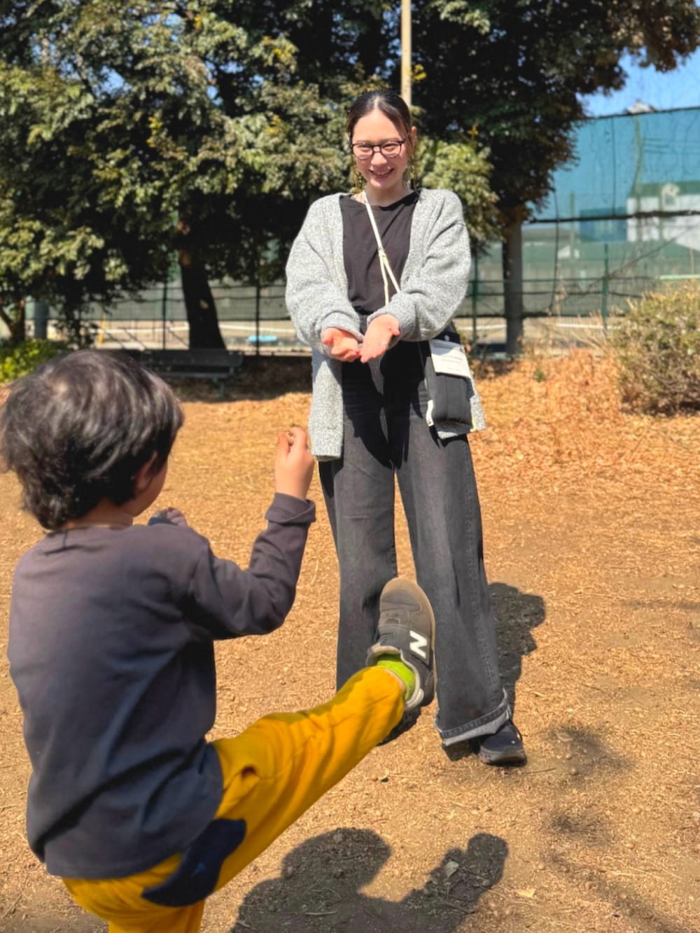 グレー系のカーディガン/ボレロ、ブラック系のショルダーバッグ、ブラック系のサロペット/オーバーオールを着用したレディースの春コーディネートの3枚目の写真