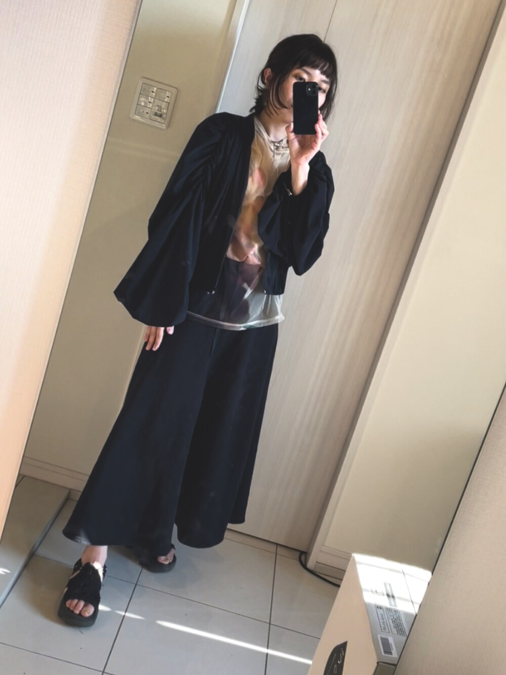 ブラック系のサンダル、ブラック系のワンピース、その他のTシャツ/カットソーを着用したレディースの春コーディネートの3枚目の写真