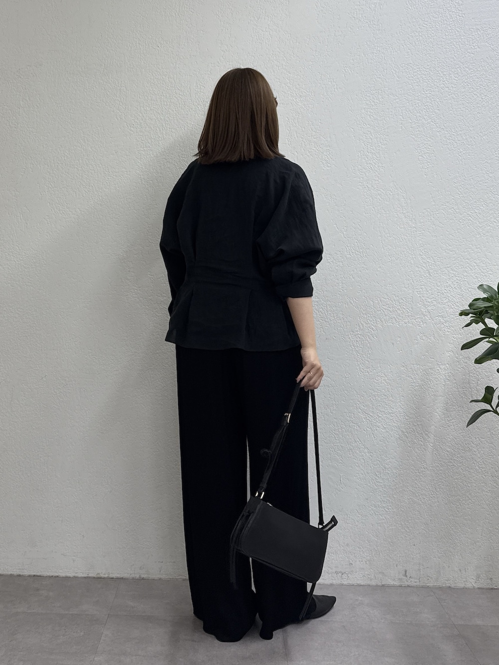 ブラック系のシャツ/ブラウス、ブラック系のショルダーバッグ、ブラック系のスリッポンを着用したレディースの冬コーディネートの3枚目の写真