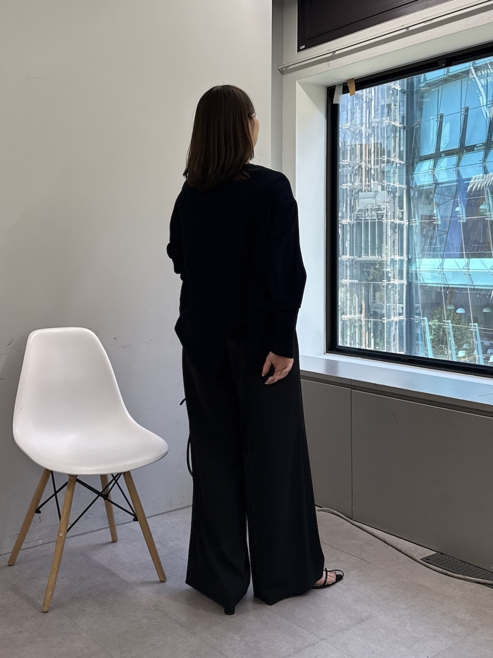 ブラック系のその他パンツ、オレンジ系のサンダル、ブルー系のシャツ/ブラウスを着用したレディースの春コーディネートの3枚目の写真
