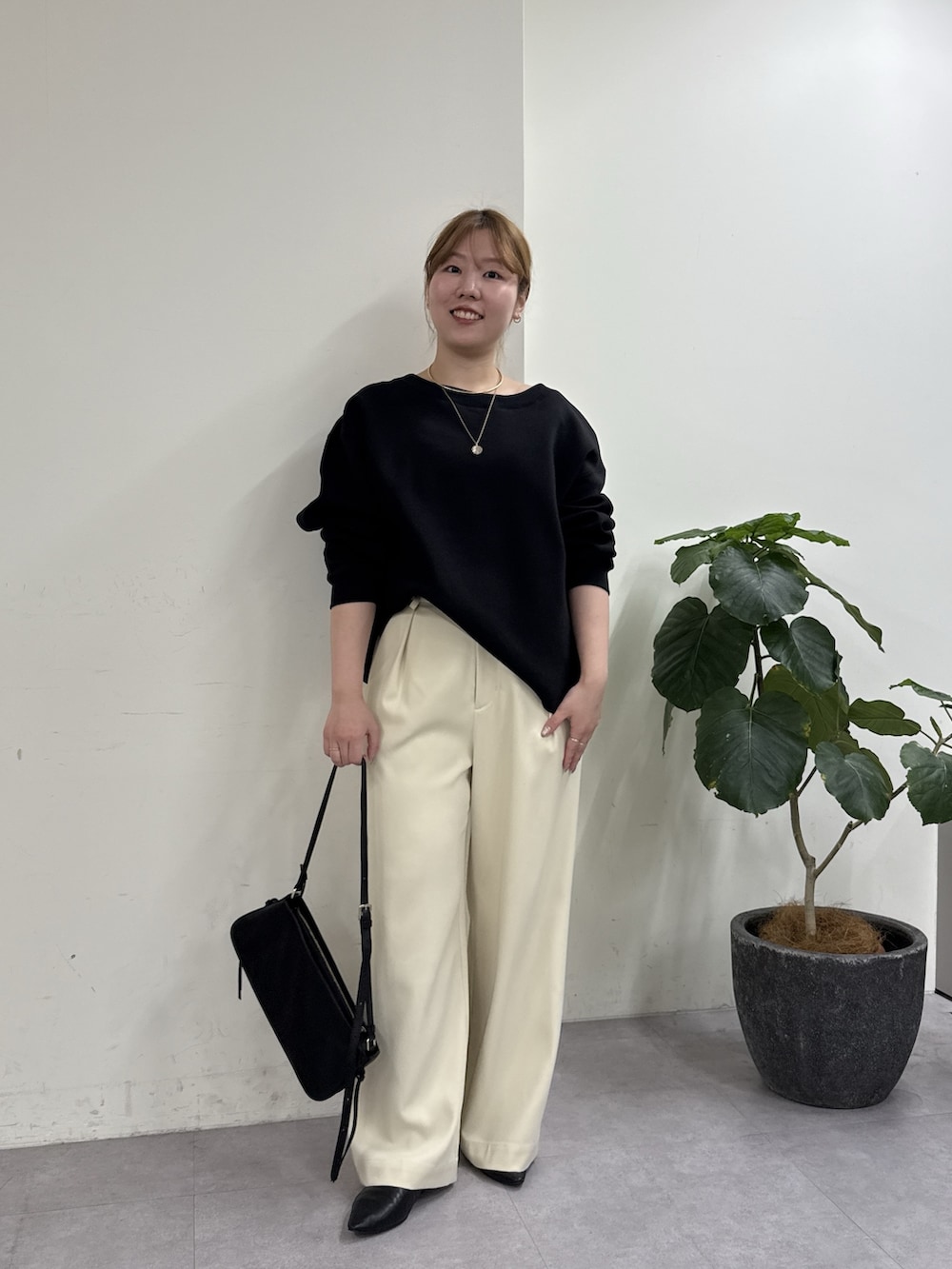 ホワイト系のその他パンツ、ブラック系のショルダーバッグ、ブラック系のTシャツ/カットソーを着用したレディースの冬コーディネートの3枚目の写真