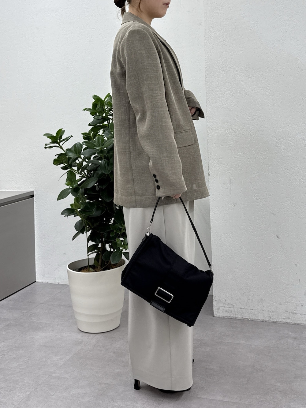 グレー系のその他パンツ、ブラック系のサンダル、ブラック系のショルダーバッグを着用したレディースの冬コーディネートの2枚目の写真