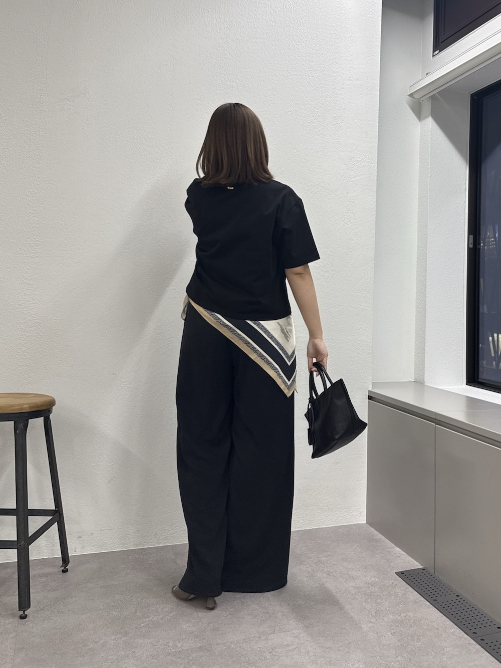 ブラック系のTシャツ/カットソー、ブラック系のトートバッグ、ブラック系のその他パンツを着用したレディースの春コーディネートの3枚目の写真