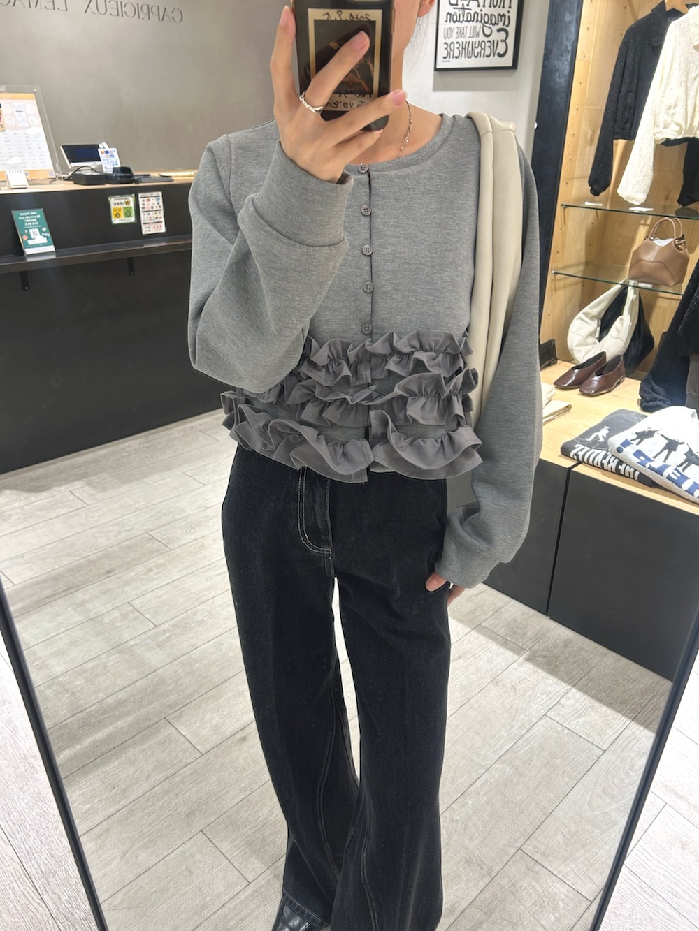 グレー系のTシャツ/カットソー、ブラック系のデニムパンツ、ブラック系のローファーを着用したレディースの秋コーディネートの4枚目の写真